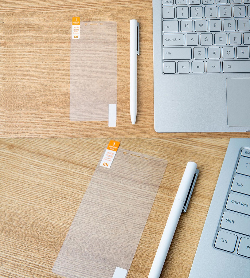 Захисна плівка до смартфонів Xiaomi Redmi 4 на столі біля автоматичної ручки та ноутбука